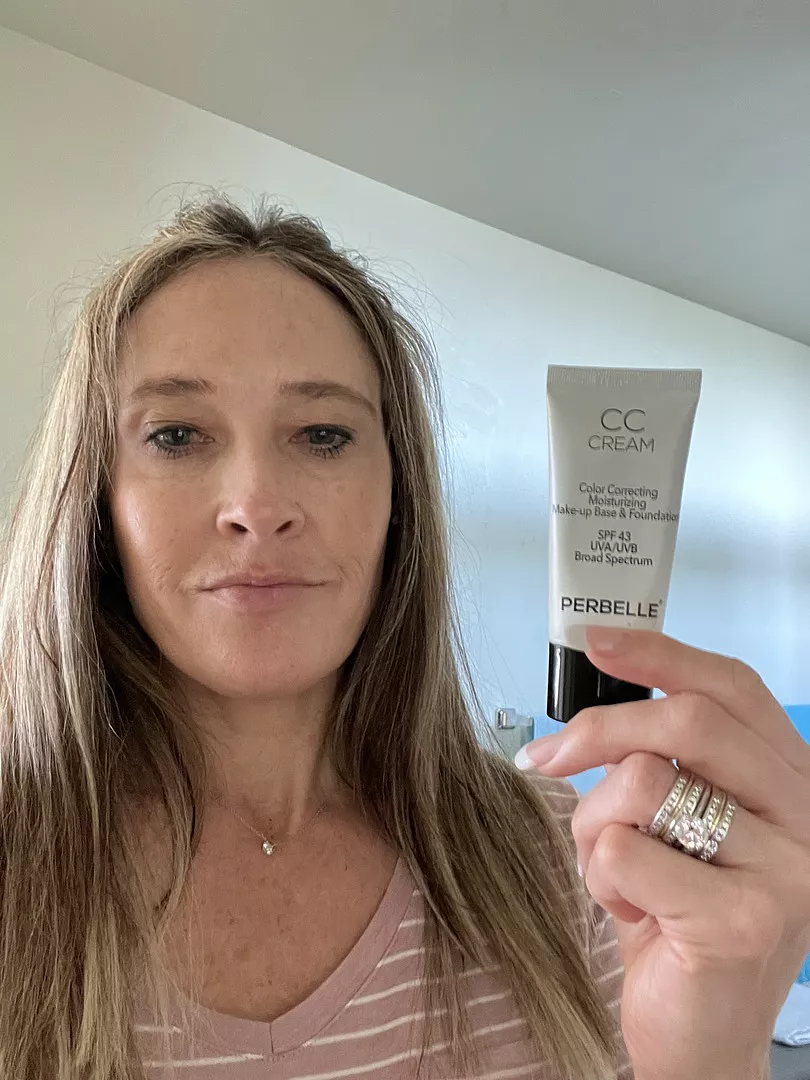 Woman holding Perbelle CC Cream tube
