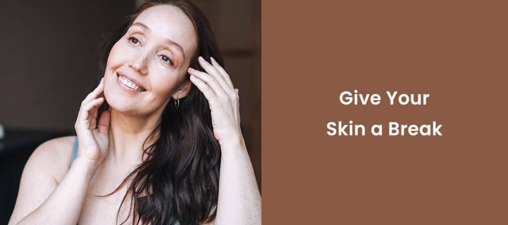 Smiling woman touching face promoting skincare break